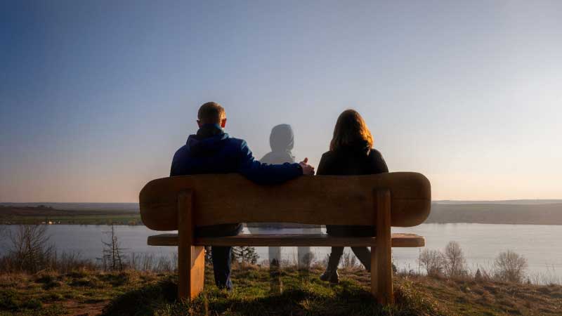Parents sitting quietly on either side of an empty swing symbolizing the loss of a child and the emotional roots of the Justice for Connor movement